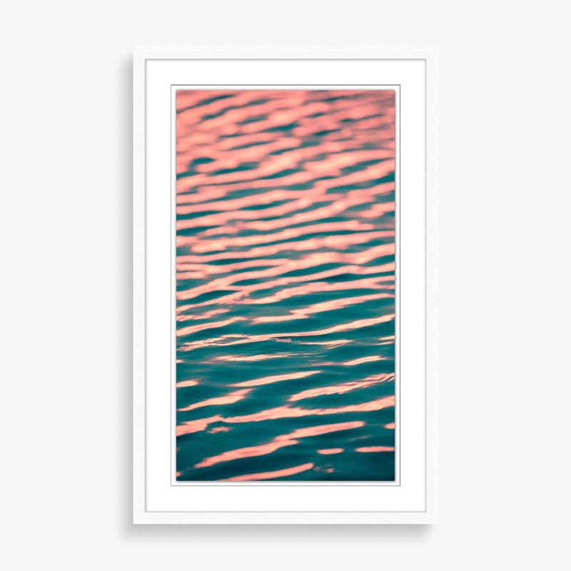 Large wall art featuring blue and pink sunset on ocean. 