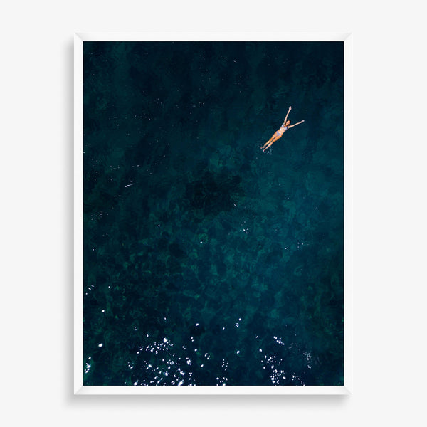 Large wall art of ocean photography featuring floating swimmer. 