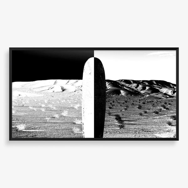Large wall art featuring beach scene with surfboard in black and white.