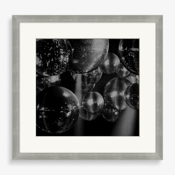 Black and white photography piece of disco balls.